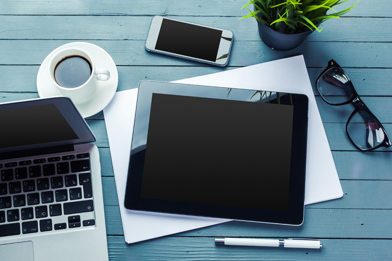 Office table with laptop and tablets on top