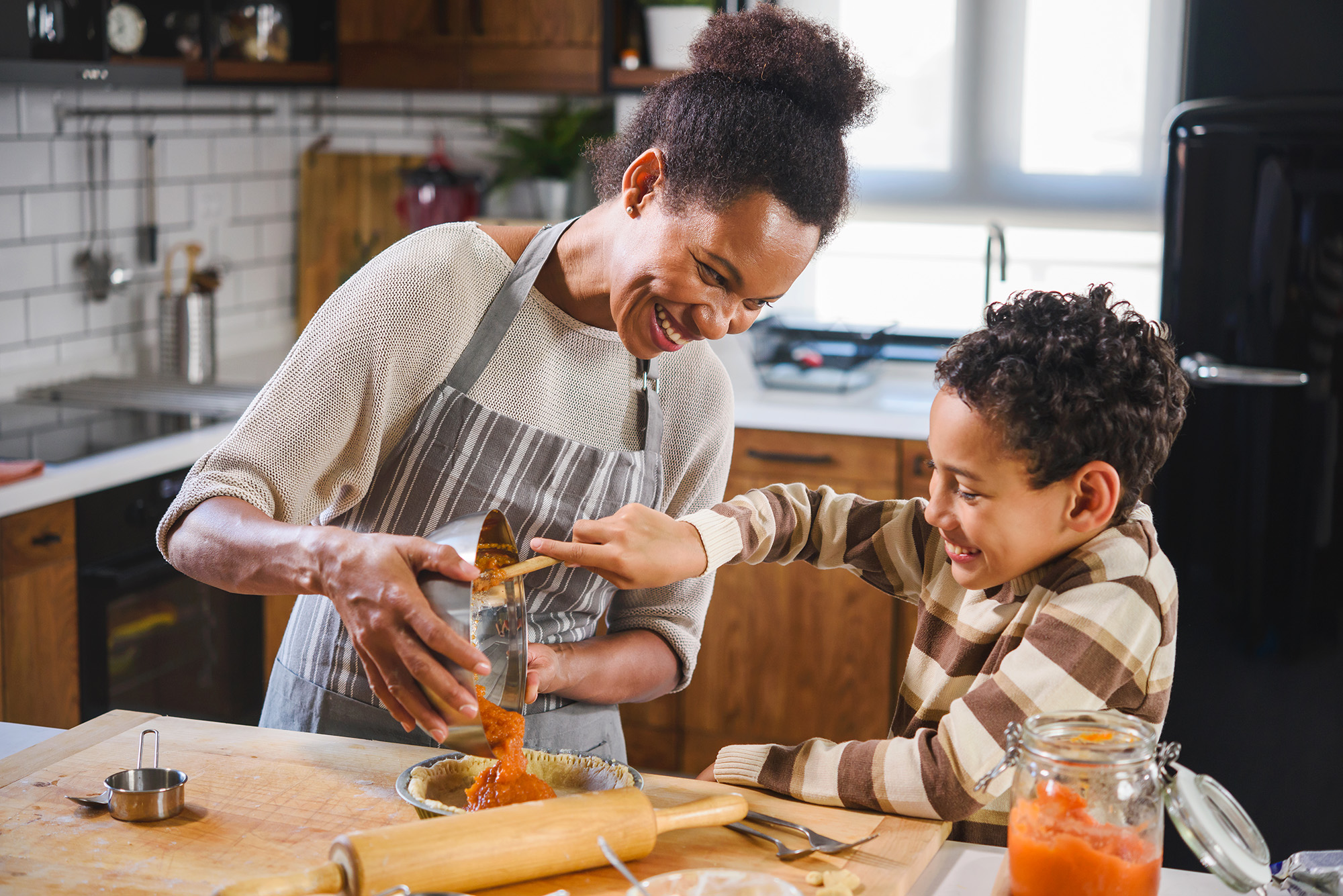 mother baking with her young son in the kitchen